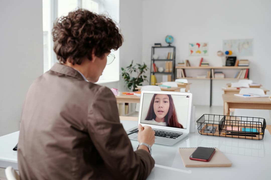 Educator and student connecting through a video call