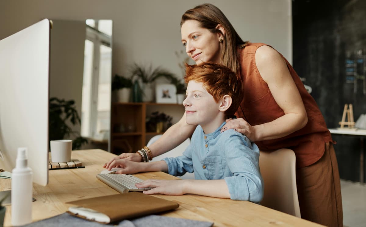 Parent supporting child during an online learning session